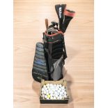 A Wilson golf bag containing irons and drivers, a box of golf balls and a Dunlop tennis racket.