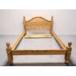 A contemporary pine 4'6 bed frame, together with a three drawer bedside chest,
