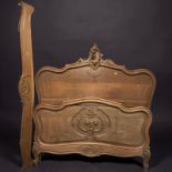 A French carved oak double bed frame, circa 1900,