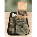 A group of militaria comprising a British WWII white canvas land mine marker dated 1944,