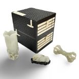An important group of three Chinese jade carvings in an ebonised collector's cabinet with all over
