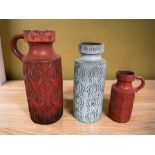 Two 1970's West German pottery jugs and a further vase, tallest 46 cm.