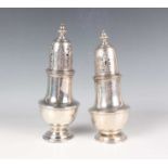 A pair of George V silver sugar casters, each of baluster form with a pierced and engraved domed