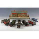 A collection of Hornby O gauge railway items, including clockwork 4-4-0 locomotive and tender 2711