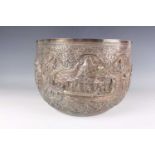 A late 19th century Burmese silver thabeik bowl of steep-sided circular form, repoussé decorated