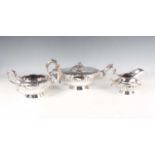 A William IV Irish silver three-piece tea set of squat circular form, chased with a band of