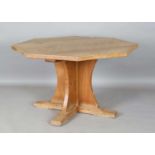 A Robert 'Mouseman' Thompson oak octagonal dining table, the adzed top above a quatreform base