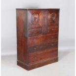 An Edwardian Arts and Crafts Heal & Sons oak 'Owl' cabinet, designed by Sir Ambrose Heal in 1905-06,