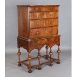 A George I walnut chest of oak-lined drawers, raised on a later made stand, fitted with a drawer