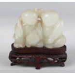 A Chinese pale celadon jade figure group, Qing dynasty, finely carved and pierced with two boys
