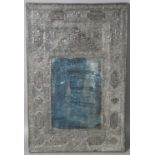 A Persian silver mounted rectangular mirror, late 19th/early 20th century, embossed with panels of