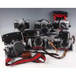 A collection of nine Praktica and Pentacon cameras and lenses, including Praktica MTL 50 camera with