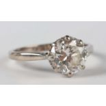 A white gold, platinum and diamond single stone ring, claw set with a circular cut diamond, detailed