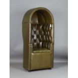 A 20th century green leather and brass studded porter's chair with typical domed top and buttoned