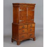 An early 18th century walnut collector's cabinet-on-chest, fitted with a cushion frieze drawer above