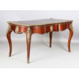 A 20th century French burr wood and gilt metal mounted bureau plat, the serpentine top inset with