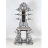 A Victorian cast iron hallstand by Coalbrookdale & Co, the arched pediment above a mirror and