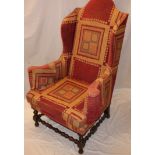 A good quality traditional wing easy chair upholstered in patterned fabric on bobbin-turned legs