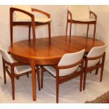 A 1960's Danish teak dining suite by K S Denmark comprising a teak circular extending dining table