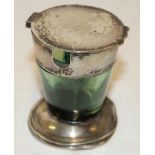 A silver mounted green tinted glass tapered inkwell by Waring and Gillow of London with circular