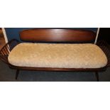 A 1960's Ercol dark day bed with upholstered cushions