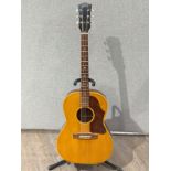 A Gibson acoustic guitar circa 1966, thought to be a B25, serial no. 384268, adaptations present