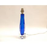 A Flygfors Paul Kedelv designed glass table lamp base in blue, encased in clear glass. Incised