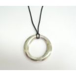 A Tiffany and Co Elsa Peretti Sevillana silver pendant, 5cm diameter on black cord, in pouch