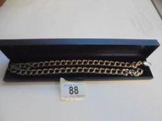 A heavy silver neck chain, 61 grams.