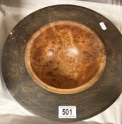 A large turned wood bowl with Burr Elm H stamped to bottom featuring a textured rim