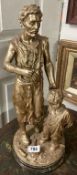 A large antique gilded metal statue depicting a man and a boy