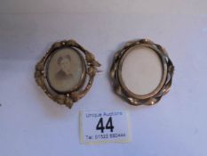 Two 19th century yellow metal photo brooches (one missing its pin).
