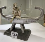 A statue of Ancient Egyptian Goddess Isis in a solar barge