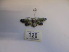 A silver butterfly brooch.