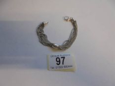 A silver multi strand bracelet.