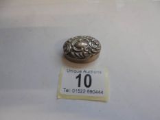 A small silver pill box.