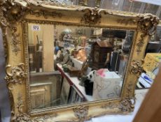 An antique French giltwood mirror with bevelled plate