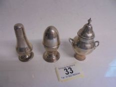 Three silver pepper pots, 75 grams.