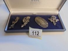 Three good silver marcasite brooches and one other.
