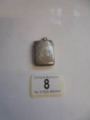 A monogrammed silver vesta case.