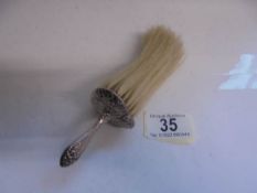 A silver handled 19th century clothes brush.