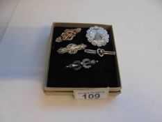 Five vintage silver brooches.