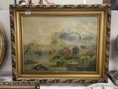 A large gilt framed oil on canvas painting featuring cattle in a Scottish landscape signed J.P.A