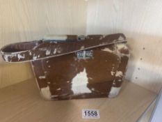 A vintage cowhide covered vanity handbag.