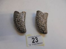 A pair of ornate silver posy holders.