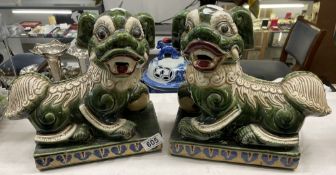 A pair of green Chinese ceramic dogs of foo