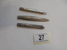 Three silver pencil holders.