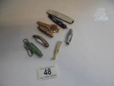 Eight vintage pocket knives including 1 silver & mother of pearl and novelty examples.