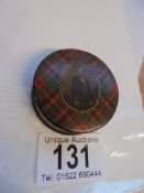 A Victorian tartan patterned wooden snuff box with male image on lid.