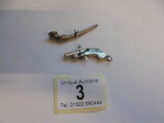 An unusual pocket watch key in the form of a horse hoof and a miniature pistol.